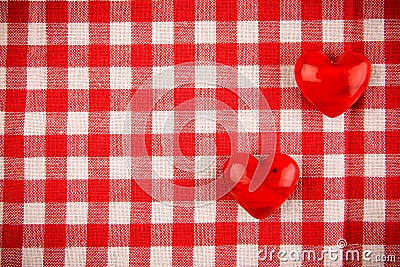 Textile texture in red and white cell with two red hearts