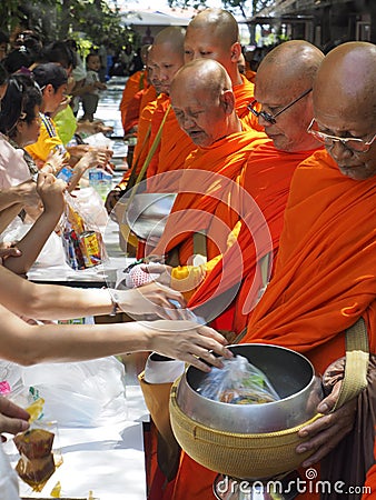 Thai people offer food to monks on Visakha Bucha, Thailand