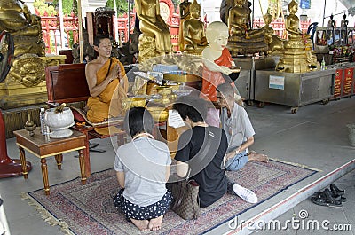 Thai people praying at wat trimit temple