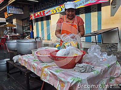 Thai woman selling food in the streets, Thailand