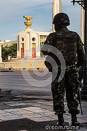 Thailand Democracy Monument with soldier silhouette