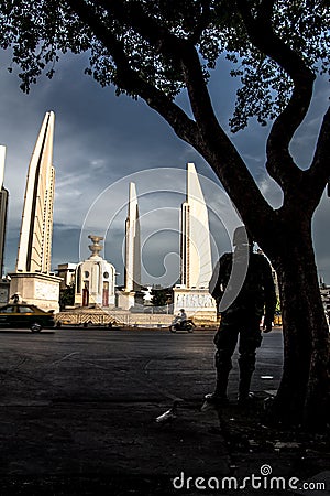 Thailand Democracy Monument with soldier silhouette