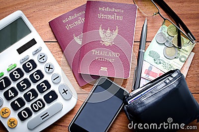 Thailand Passport with currency on teak wood .