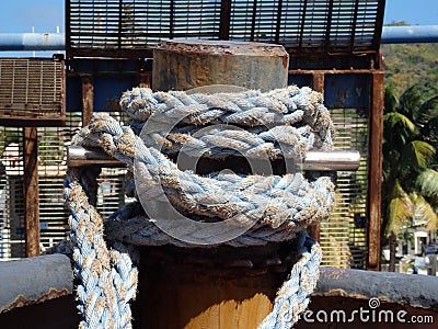 Thick rope tied around a steel bollard