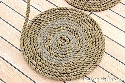 Thick rope wrapped in spiral lying on deck of ship