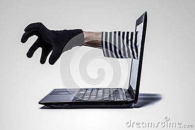 Thief s hand reach out of computer