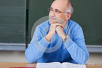 Thoughtful male teacher in class