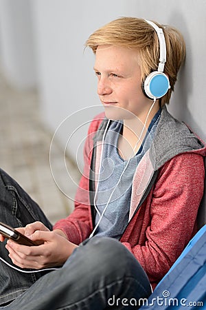 Thoughtful teenage student listening to music