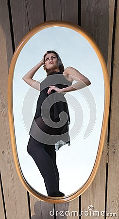 Thoughtful woman with her reflection in mirror