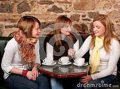 Three beautiful young students in bar