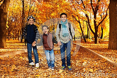 Three brothers in autumn park