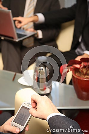 Three Business men working on electronic devices - close up