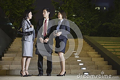 Three Business People Talking At Park