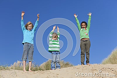 Three Children Arms Raised Having Fun on Beach