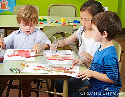 Three children painting
