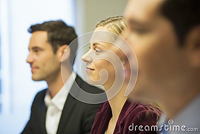 Three colleagues sitting at a business meeting, focus on pretty