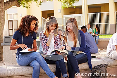 Three Female High School Students Working On Campus