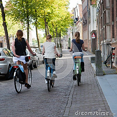 Three Girls Cycling in Amsterdam