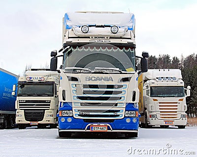 Three Long Haulage Trucks in Snowfall