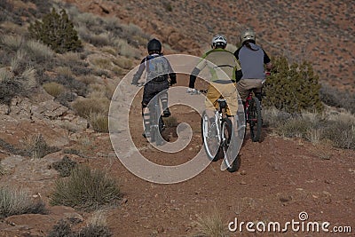 Three People Riding Mountain Bikes