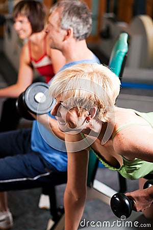 Three senior people in gym