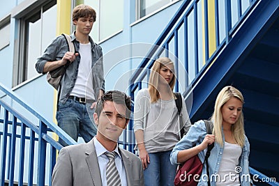 Three students walking down stairs