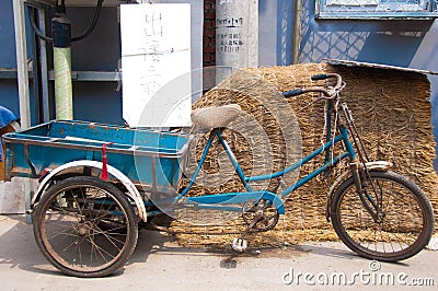 Three wheeled bike for sale in an alley in Beijing.