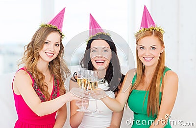 Three women wearing hats with champagne glasses