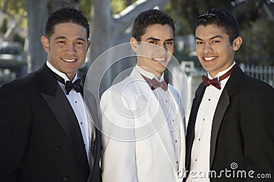 Three Young Men In Tuxedos Standing Together at Quinceanera