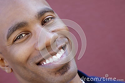 Tilt portrait of a happy African American man over colored background