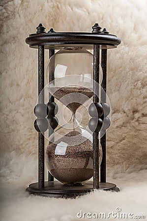 Time is money. Antique hourglass.