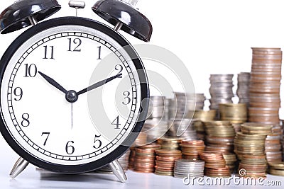 Time is Money concept with clock and coins stack