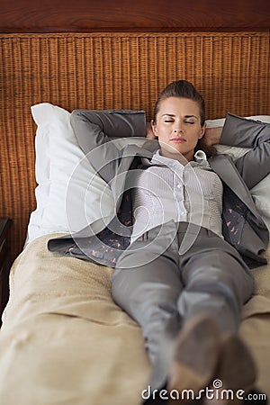 Tired business woman sleeping in hotel room