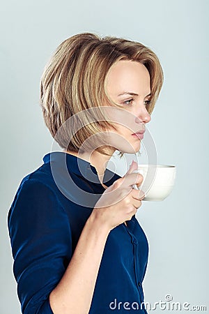 Tired business woman with tea or coffee mug