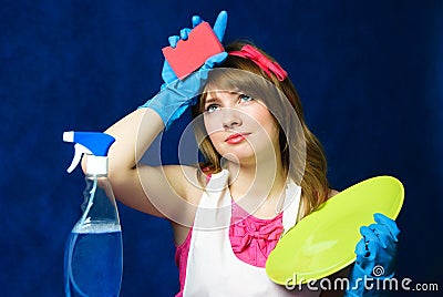 Tired housewife cleaning the dishes