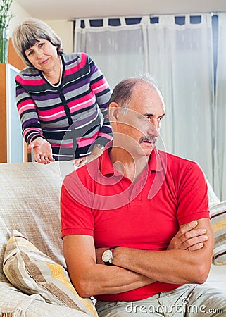 Tired mature man listening to angry wife