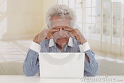 Tired Senior Businessman in front of laptop