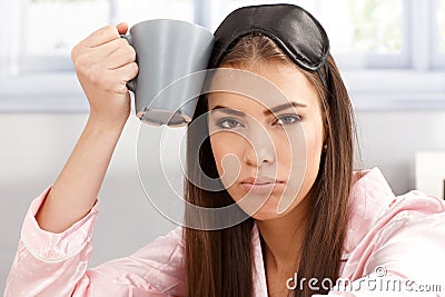 Tired sleepy woman with coffee mug