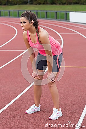 TIred sporty woman on the running track