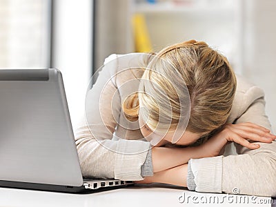 Tired woman with laptop computer