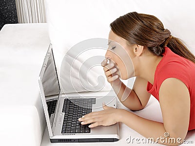Tired young woman with a computer