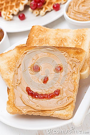 Toast with peanut butter, drawing of jam, close-up