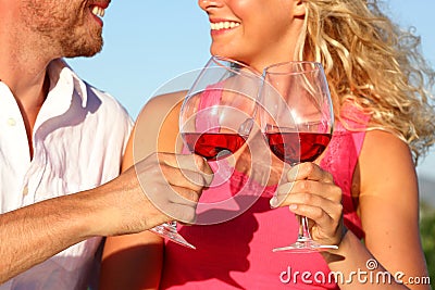 Toasting glasses - couple drinking red wine