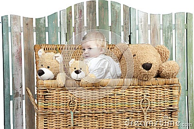 Toddler with teddy bears standing in a trunk