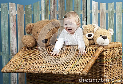 Toddler with teddy bears standing in a trunk