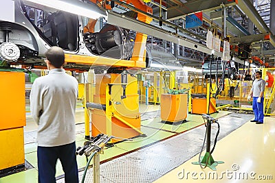 Workers and Lada Kalina bodies on line at factory VAZ