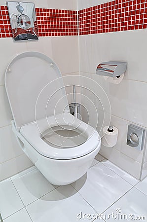 Toilet on the white floor tiles