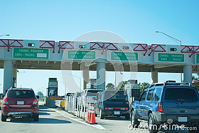 Toll booths pay station with cars waiting in line