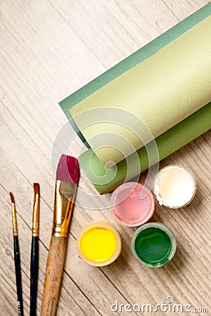 Tools of the artist: paints, brushes and a paper