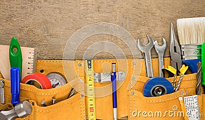 Tools in leathern belt on wood